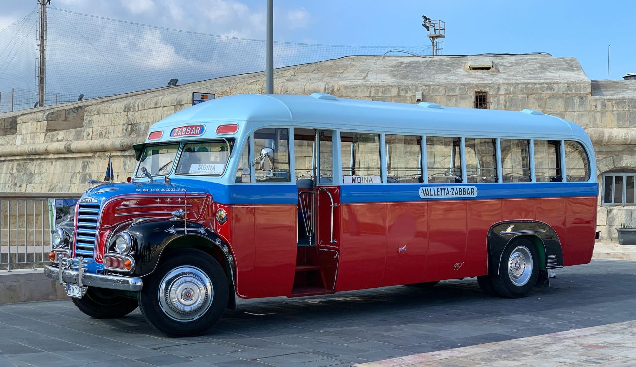 Colorful bus driving through historic streets in Malta
