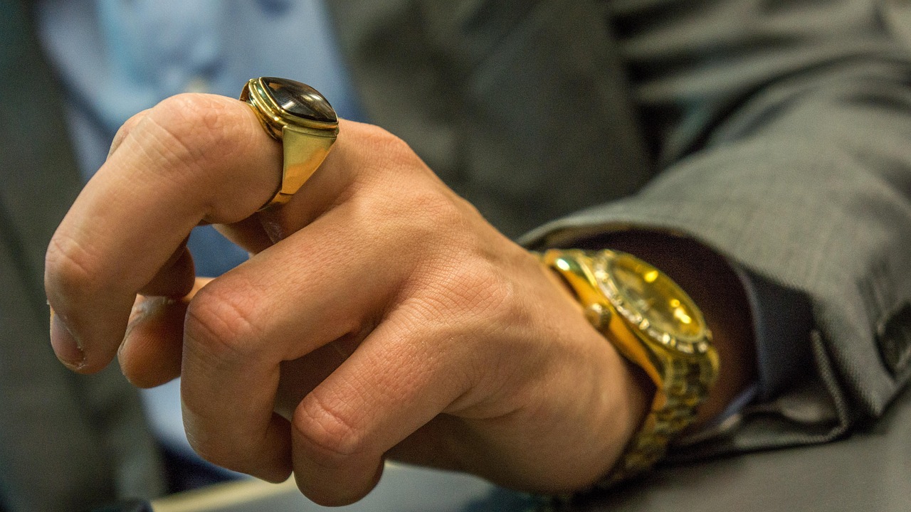 Man flashing expensive watch and ring