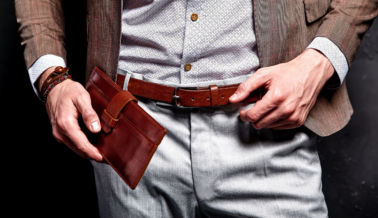 Traveler adjusting a hidden money belt.