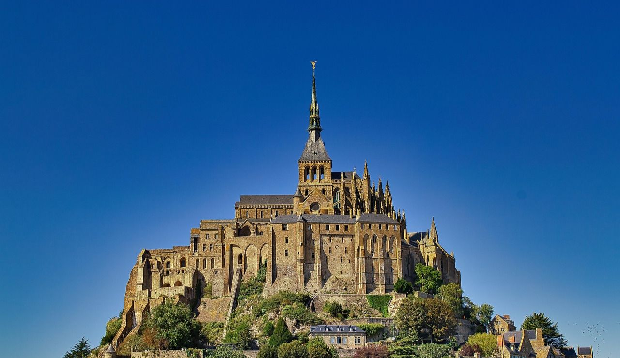 Mont Saint-Michel abbey in France under a clear blue sky.