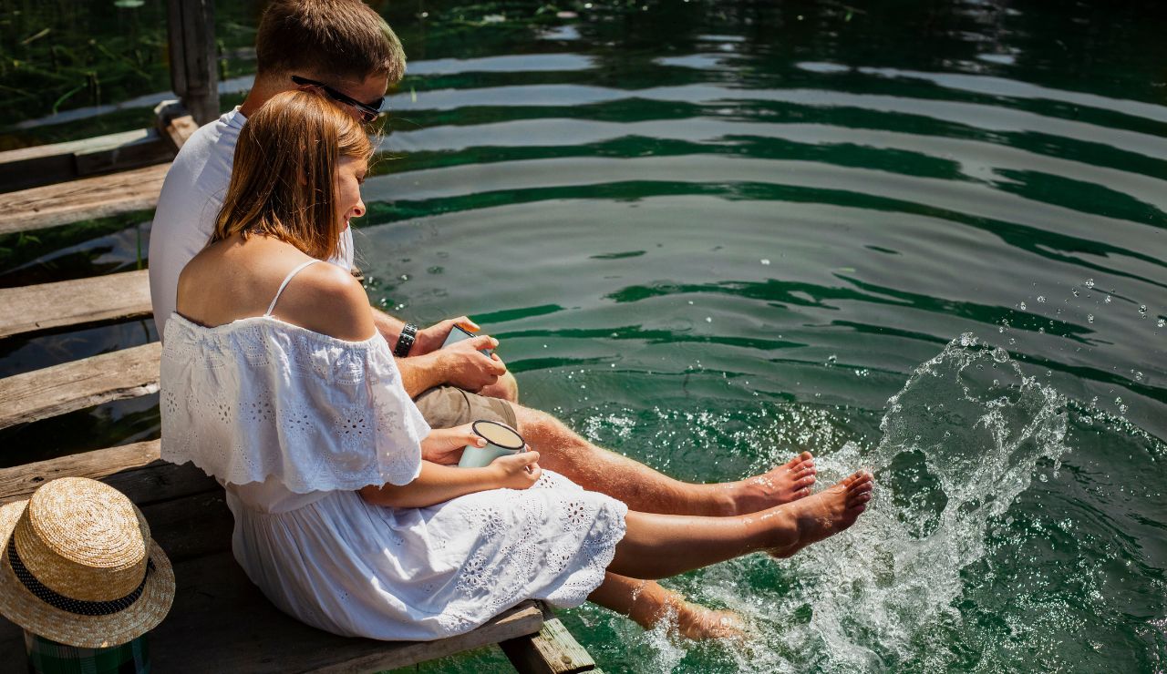 Couple relaxing on a cabin porch by Moosehead Lake.”