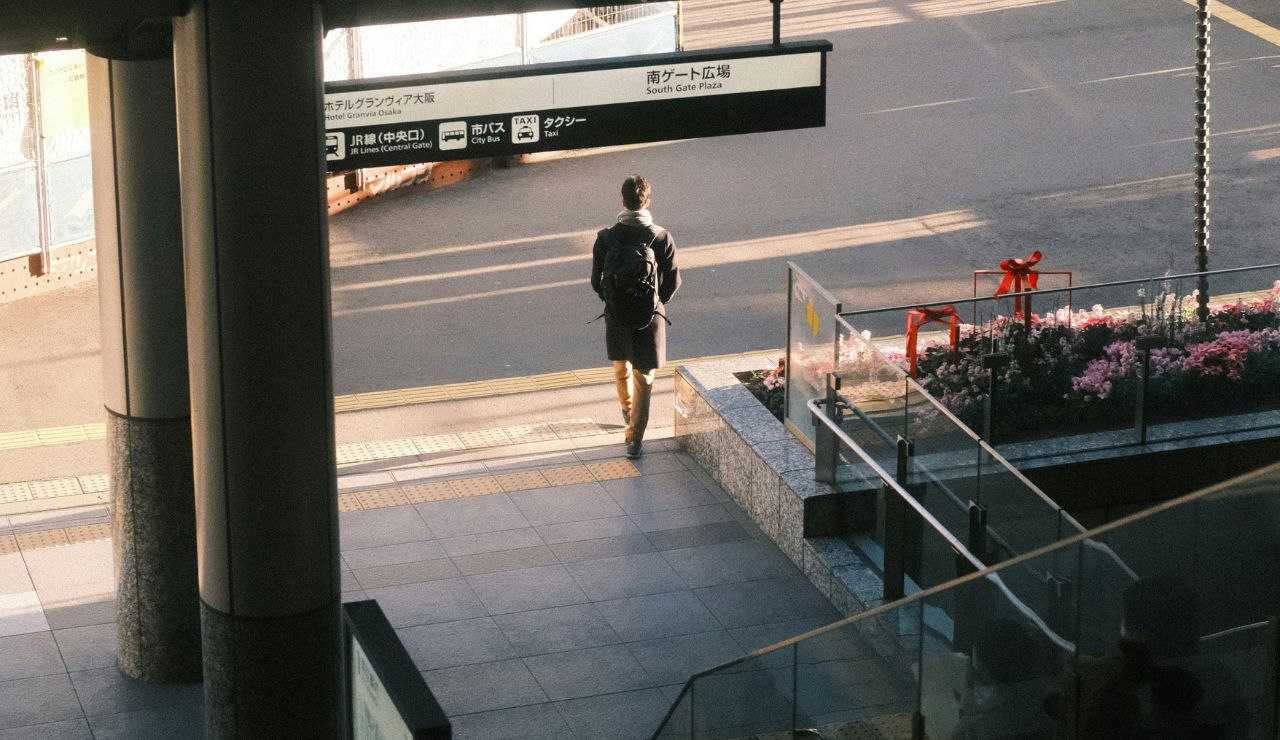 Person walking outside in morning sunlight after a flight