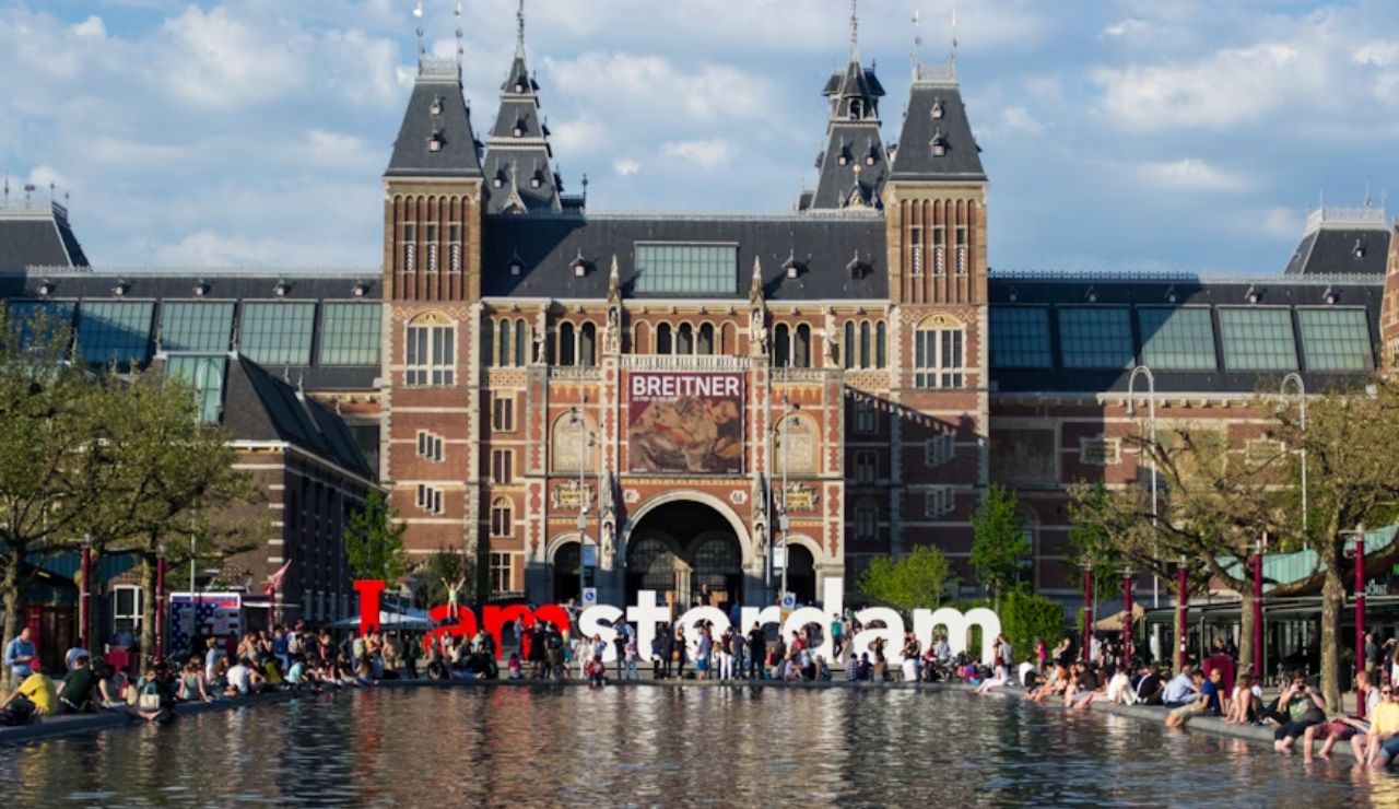 Crowds gather by the Rijksmuseum and "I amsterdam" sign in Amsterdam.