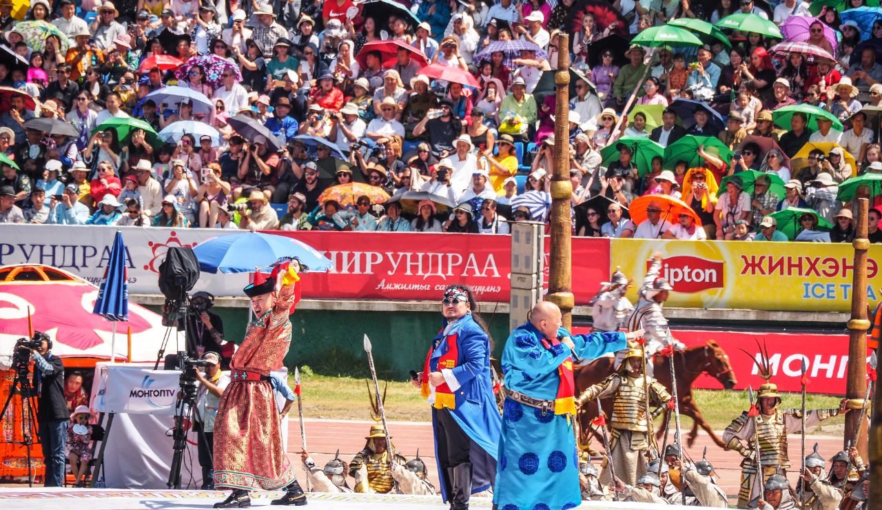 ChatGPT said:
Performers in traditional Mongolian attire take part in a colorful cultural ceremony during the Naadam Festival, as a large crowd watches from the stands with umbrellas for shade.