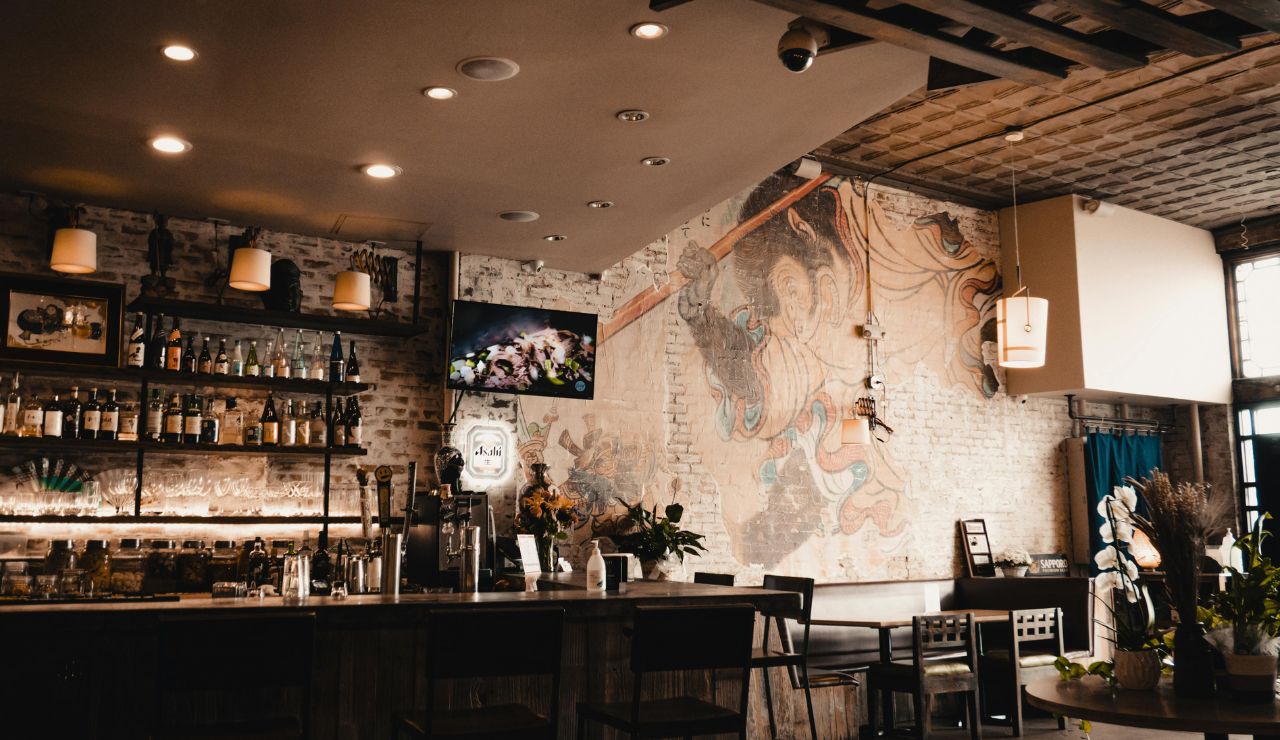 Interior of No Name Pub with walls and ceiling covered in dollar bills