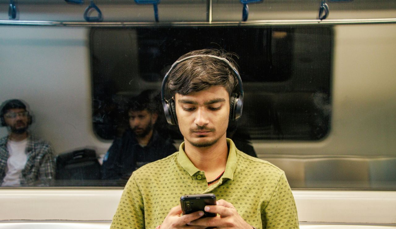 Passenger wearing noise-canceling headphones to block out cabin noise