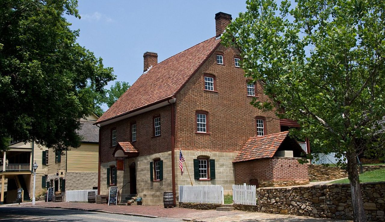 Historic red brick building with American flag in Old Salem, North Carolina.