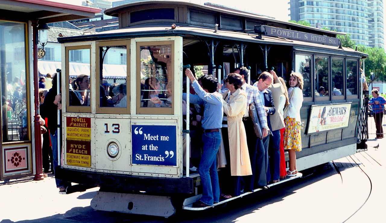 People riding a local tram or subway, surrounded by locals in everyday routines.