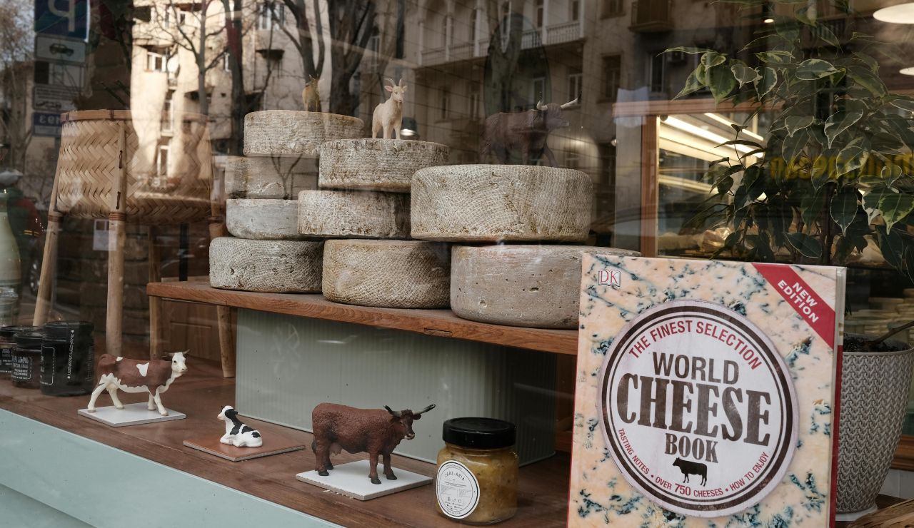Outdoor food market in Parma with prosciutto and cheese displays