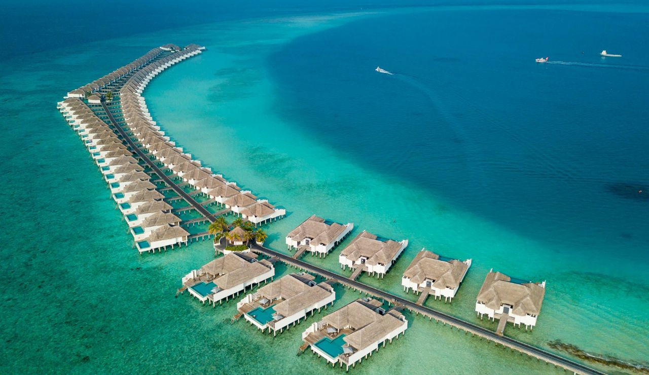 Luxury villa beachfront with calm, shallow sea.
