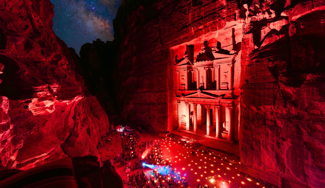  Traveler entering Petra with the Treasury visible through the narrow Siq