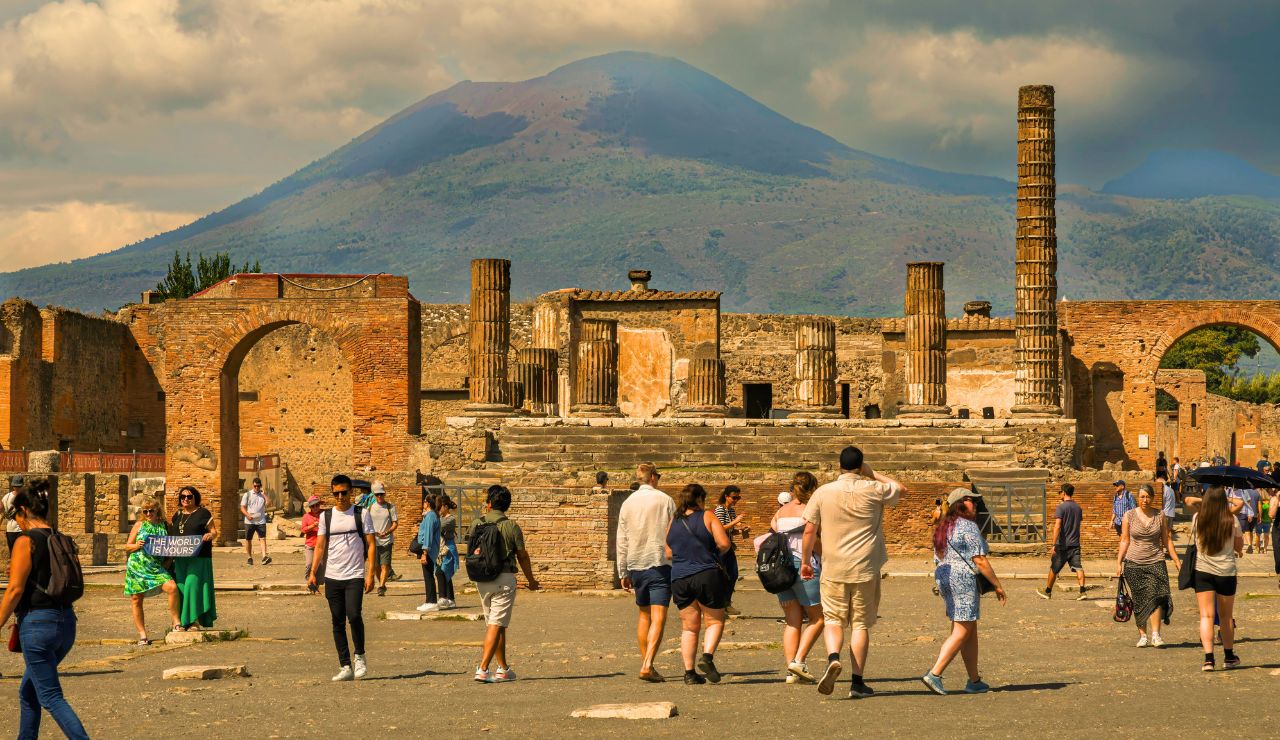  Ancient stone street in Pompeii with Mount Vesuvius in the distance