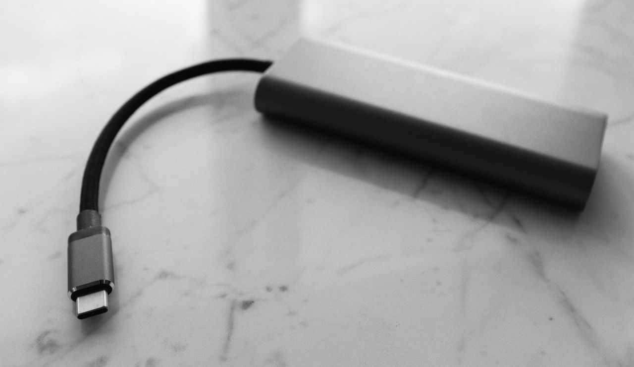 Portable charger connected to a smartphone on a table in an airport lounge.