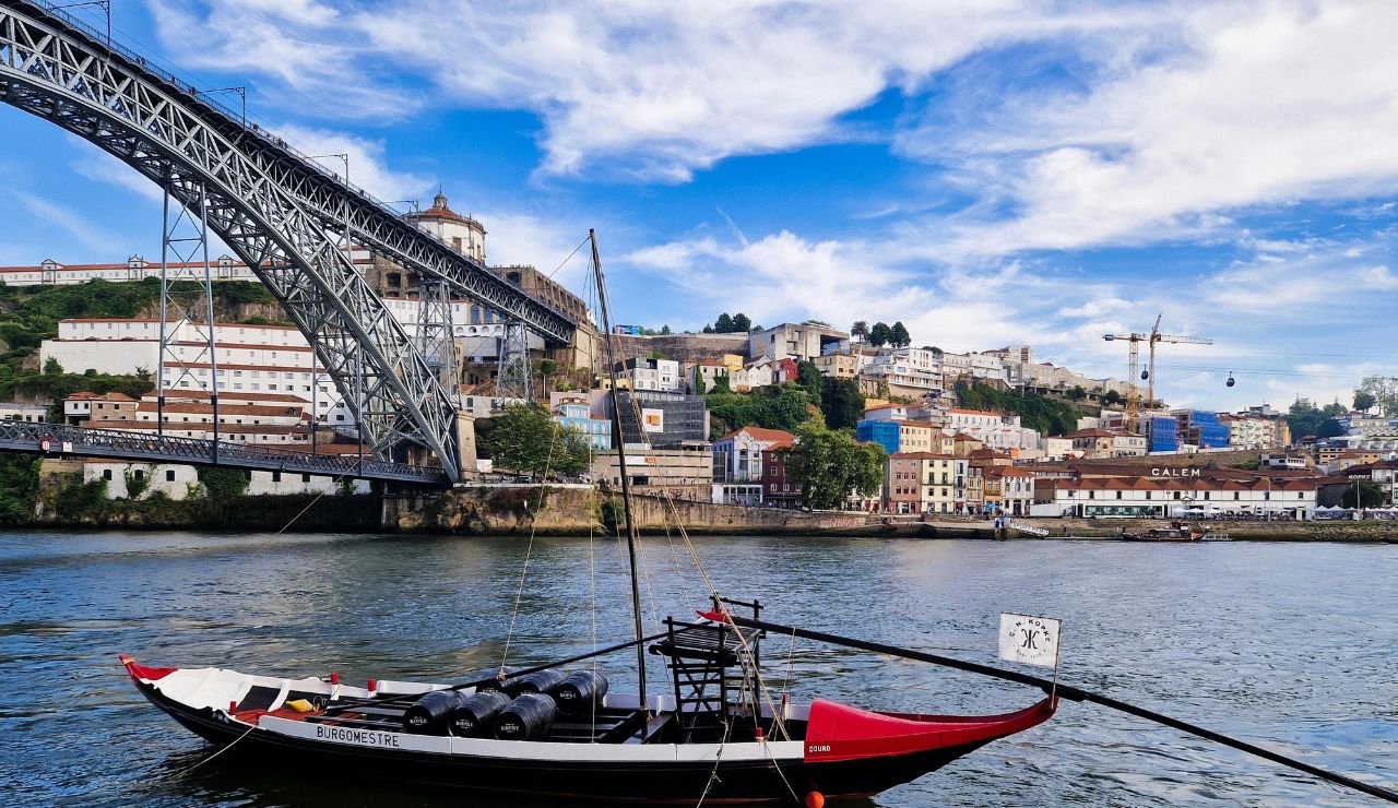 Sunset over Porto’s Douro River with rabelo boats and riverside views.