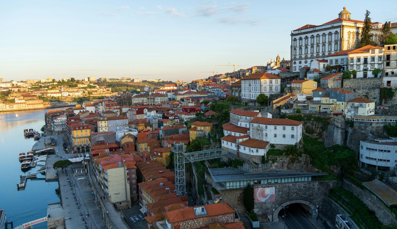 Hilltop view of Porto with tiled buildings and food stalls near the Douro River
