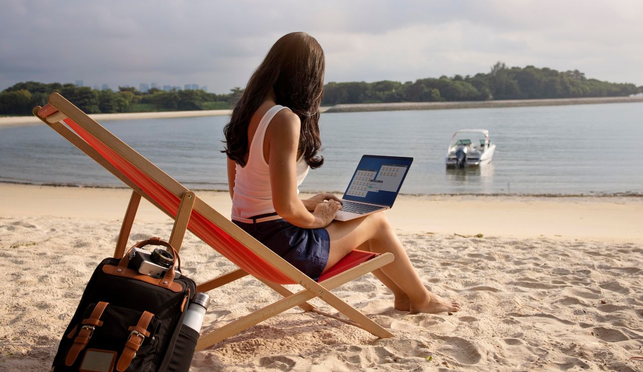 A traveler using a laptop with multiple hotel booking tabs open.