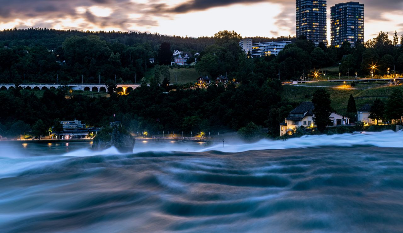 Rhine Falls glowing with night lights after sunset