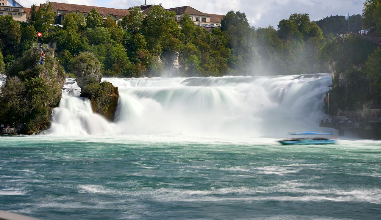 Peak summer view of Rhine Falls with massive water flow