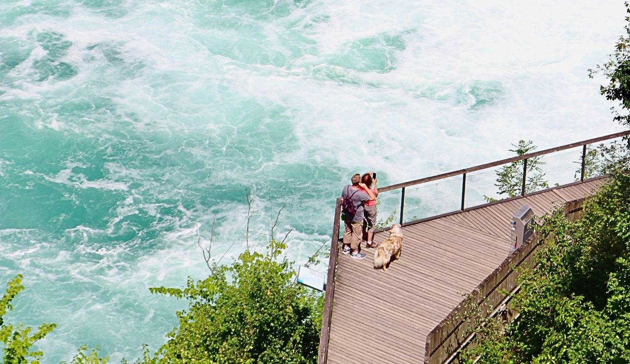 Tourists watching Rhine Falls from scenic platform