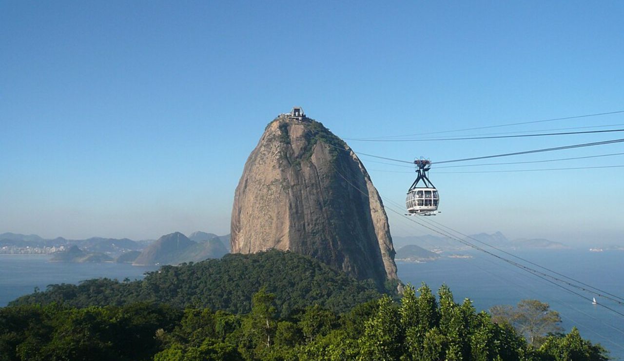 The Sugarloaf Mountain in Rio de Janeiro, with a cable car ascending towards the peak.