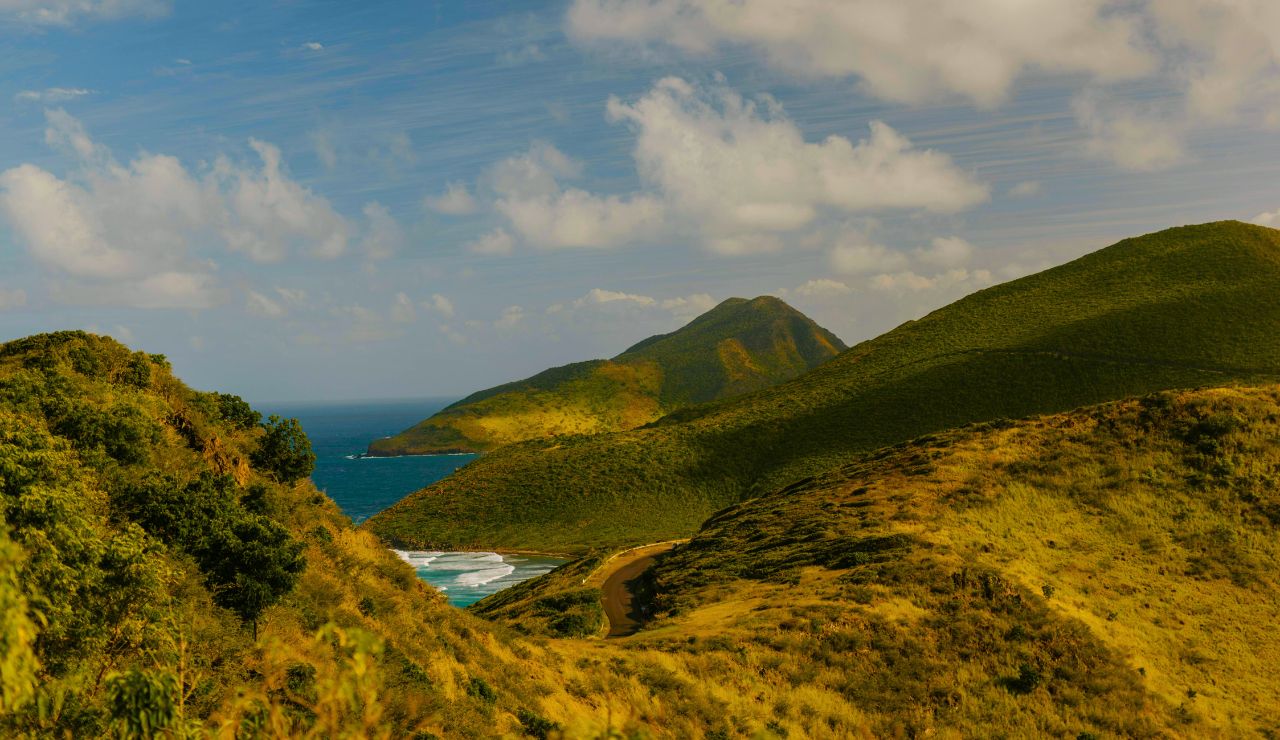  Steep jungle-covered slopes of Saba meeting sapphire Caribbean waters.