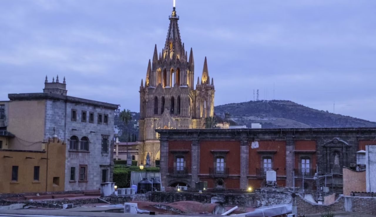 This is San Miguel de Allende in Mexico, featuring the iconic Parroquia de San Miguel Arcángel, known for its neo-Gothic façade and pink limestone spires.