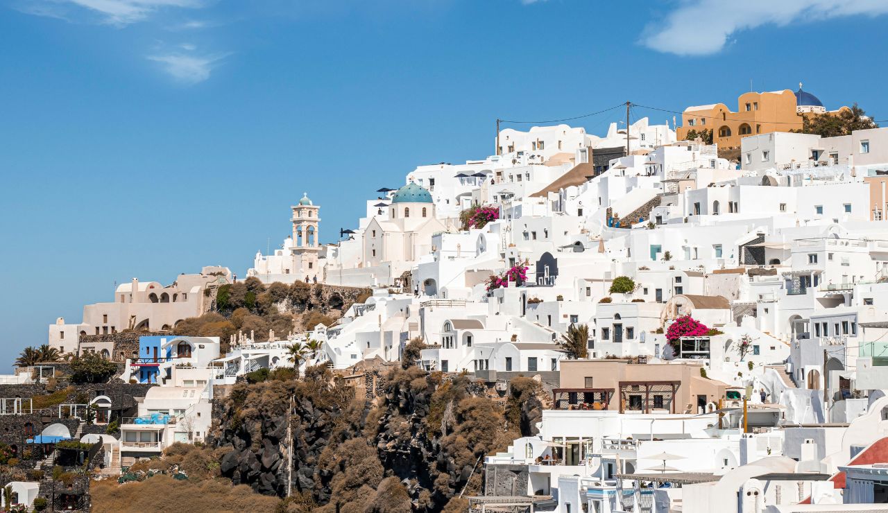 Whitewashed houses and blue domes on a cliff in Santorini