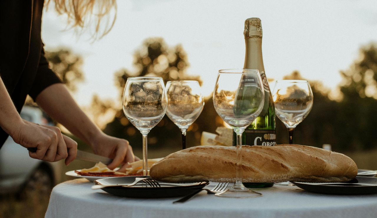 Picnic by the Seine River with baguette and wine