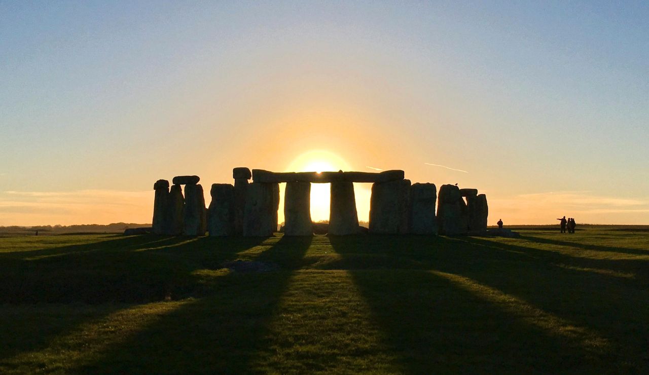 Stonehenge stone circle silhouetted at sunset.