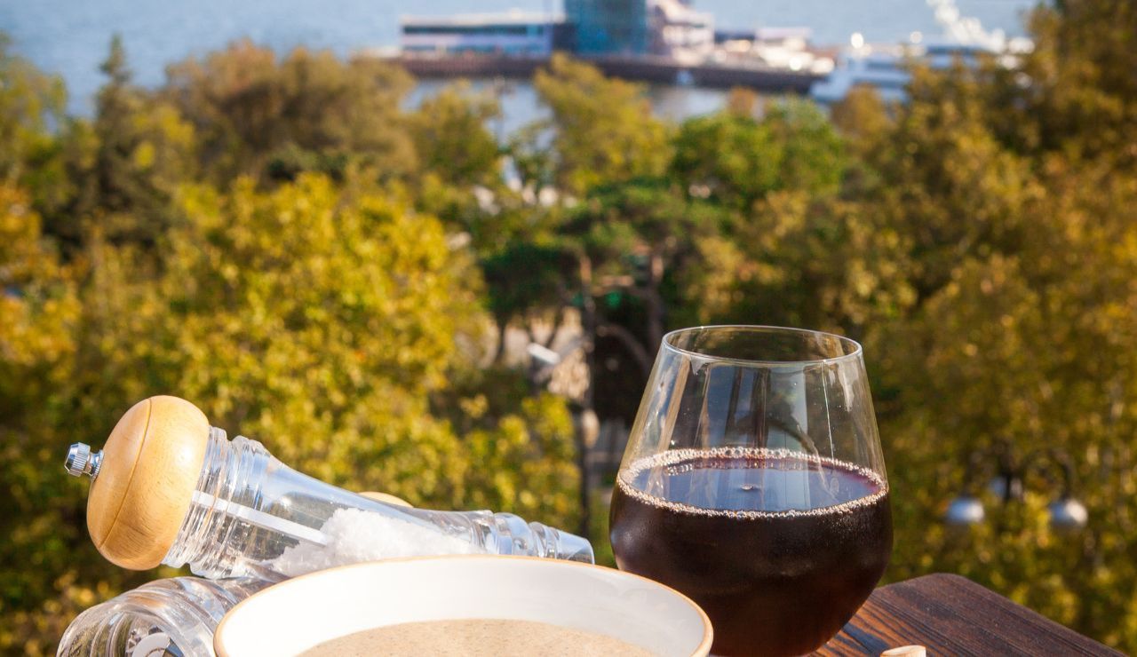 Glass of Swiss wine and chocolate tray near Rhine Falls
