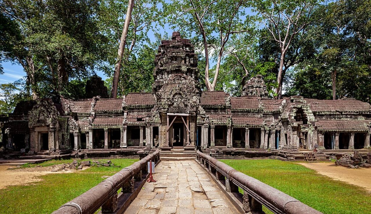 Ancient temple ruins of Ta Prohm in Cambodia, covered with jungle foliage.
