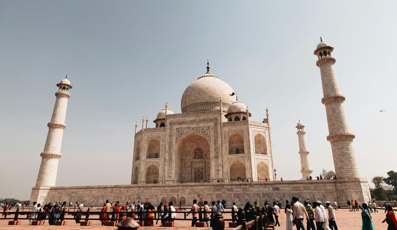 The Taj Mahal reflected in water at sunrise.
