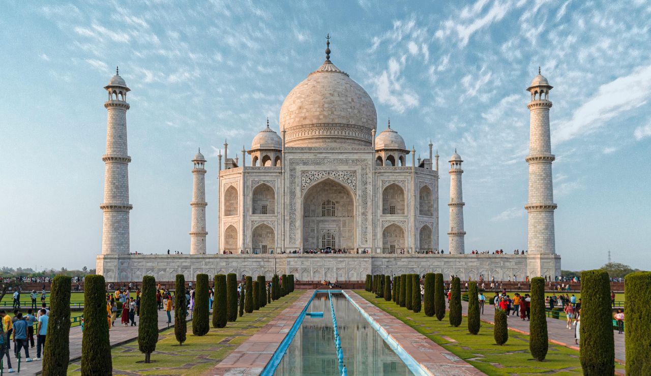 White marble Taj Mahal at sunrise with reflection pool
