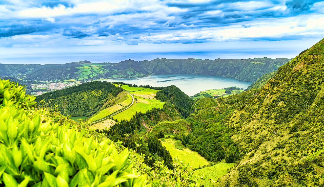 Aerial view of twin crater lakes or lush geothermal spring nestled in the Azores hills.