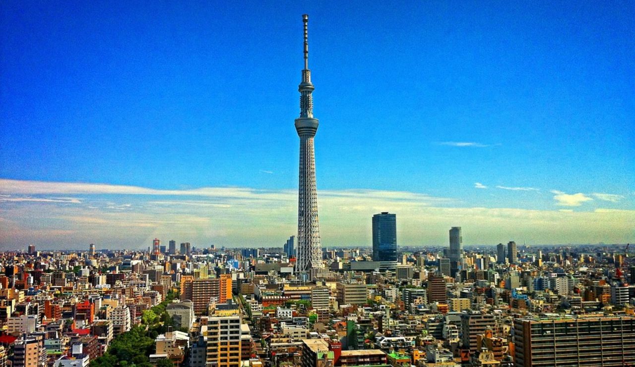 Tokyo skyline featuring the Tokyo Skytree towering above surrounding buildings on a clear day.