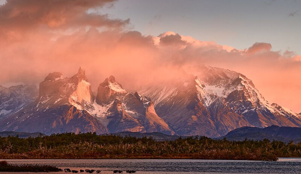 Dramatic sunrise clouds over the rugged peaks of Torres del Paine in Patagonia, Chile.