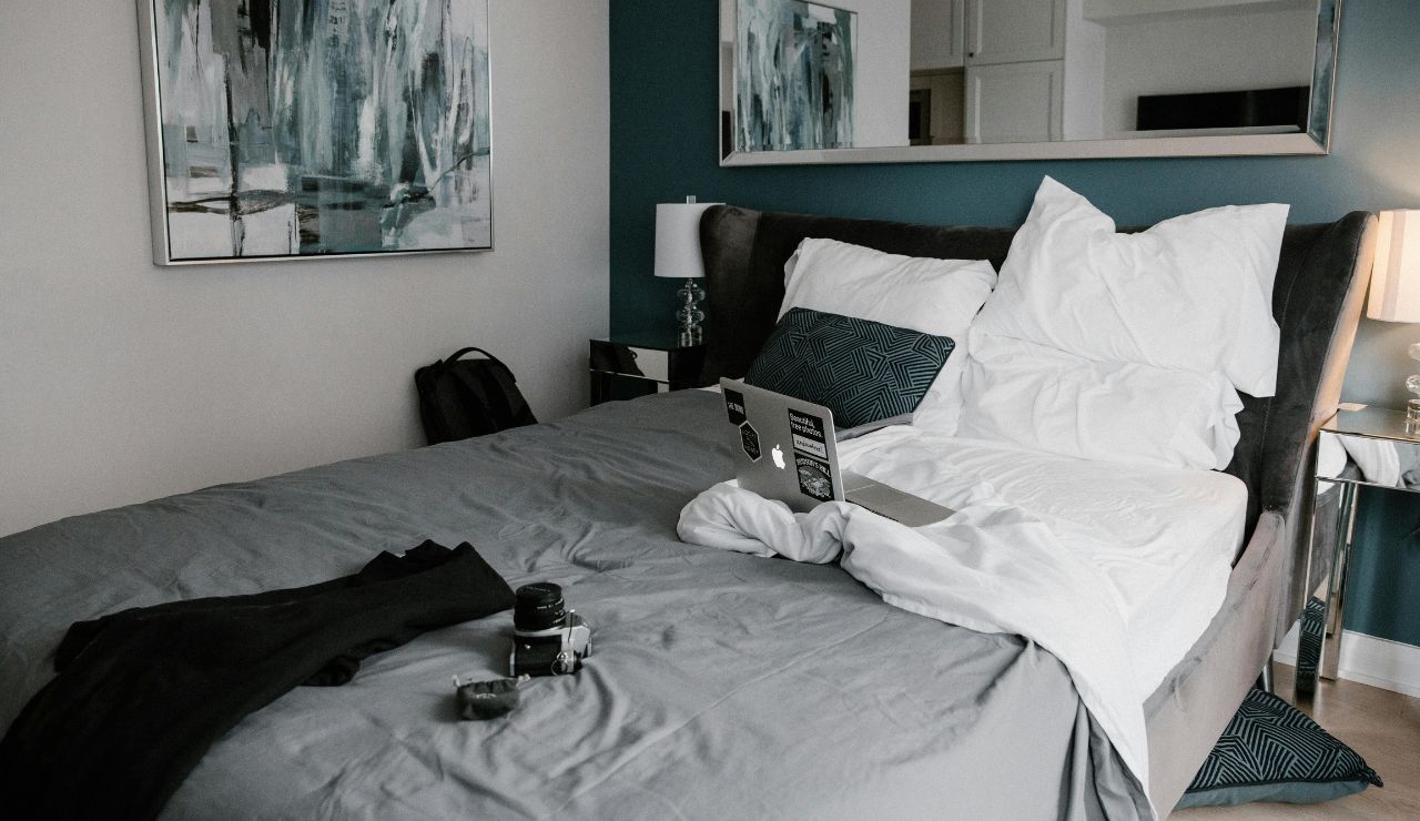 Portable travel safe locked to a bed frame.