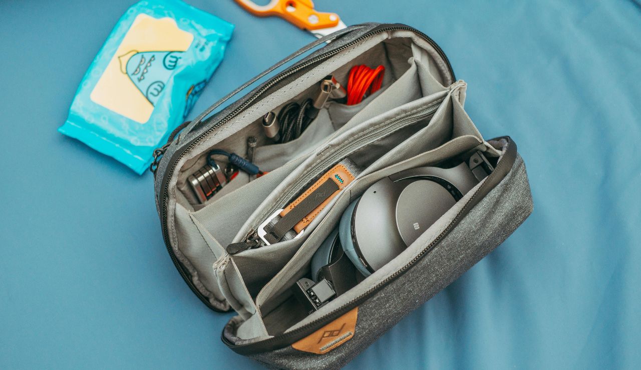 a small toiletry kit with travel bottles in a hotel bathroom.