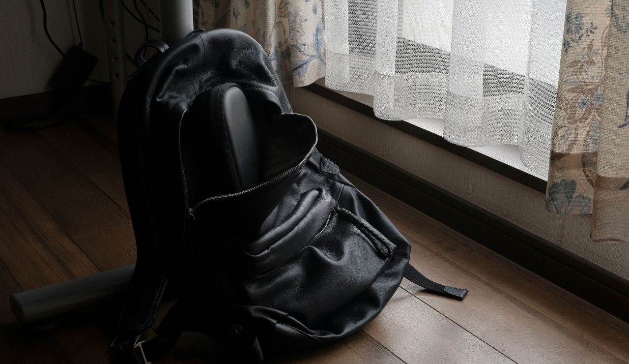Unzipped bag in a crowded travel space.
