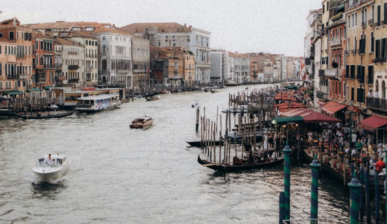 Gondolas navigating through a crowded Venice canal