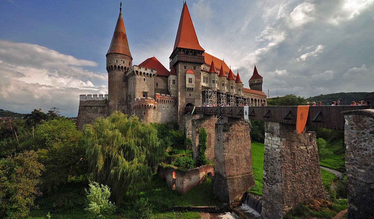 Gothic Corvin Castle with red-tiled towers and drawbridge in Transylvania, Romania
