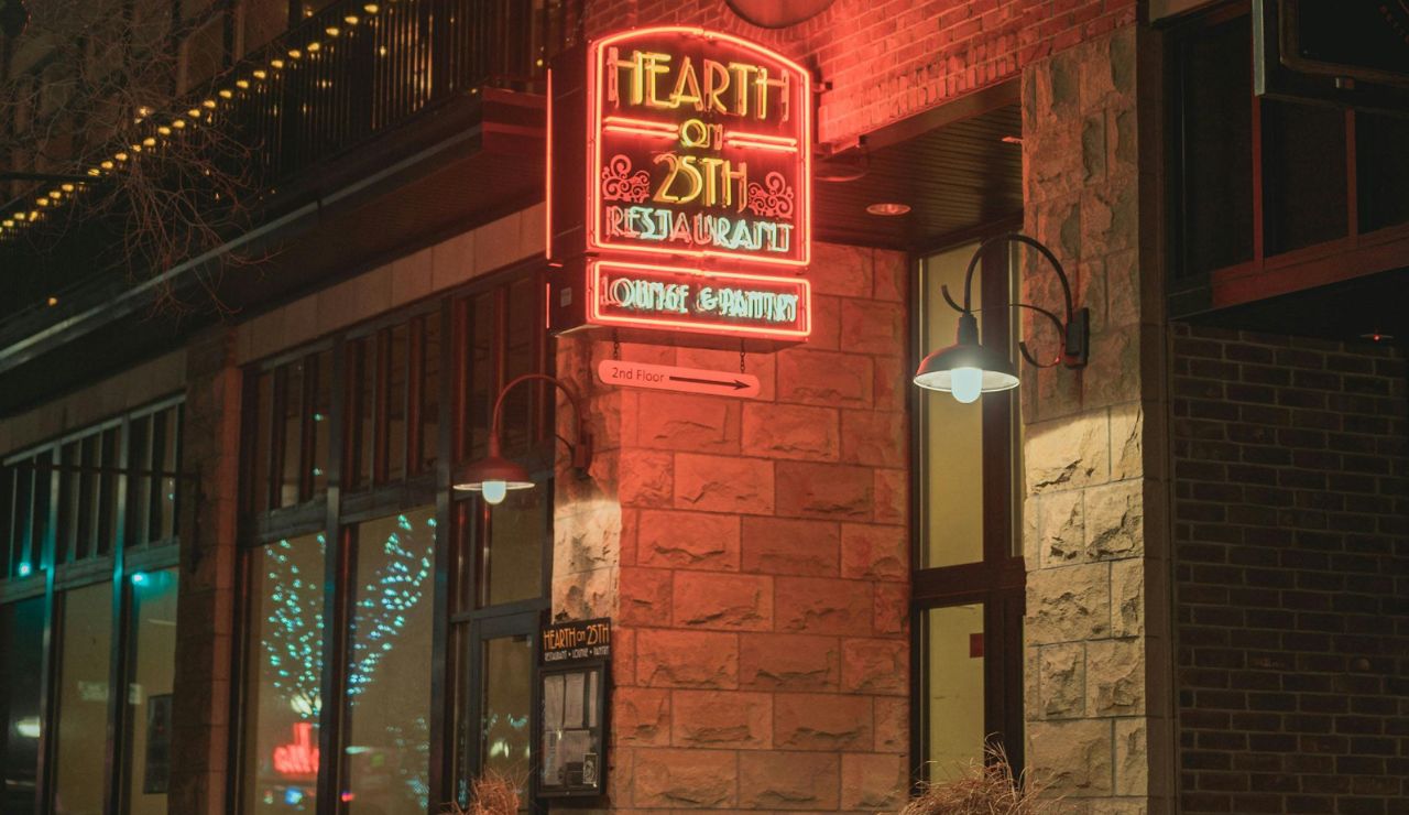 A quiet, artistic street scene with vintage brick storefronts, maybe a cafe or mural, no crowds.