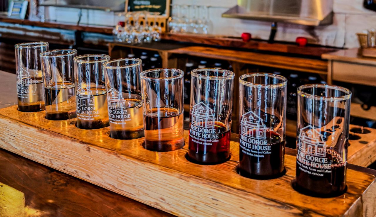A flight of craft beer on a wooden tray