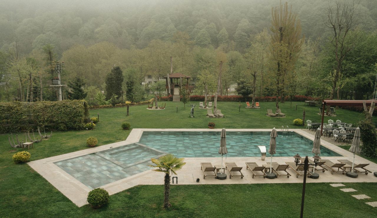 Outdoor hot spring pool surrounded by greenery