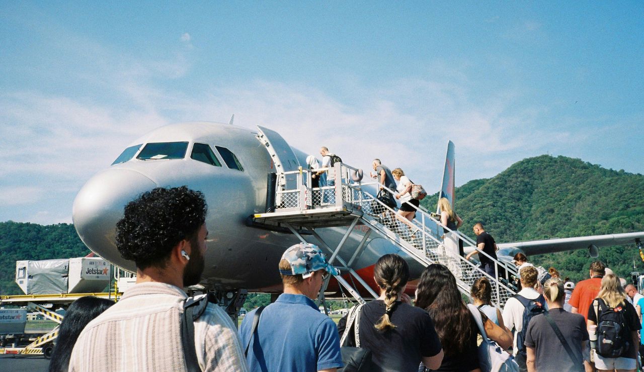 Passengers boarding a low-cost airline with extra baggage fees