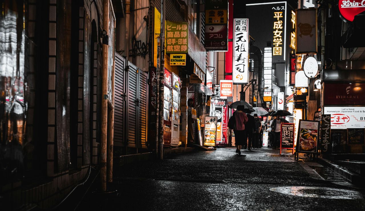 A person in Japan carrying their own trash on the street due to lack of public trash cans