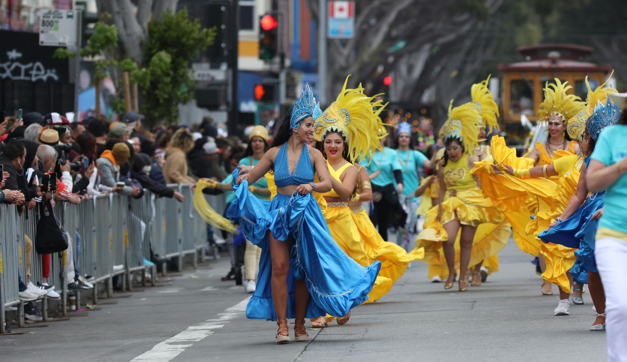 Dancers in feathered costumes performing at Rio Carnival.