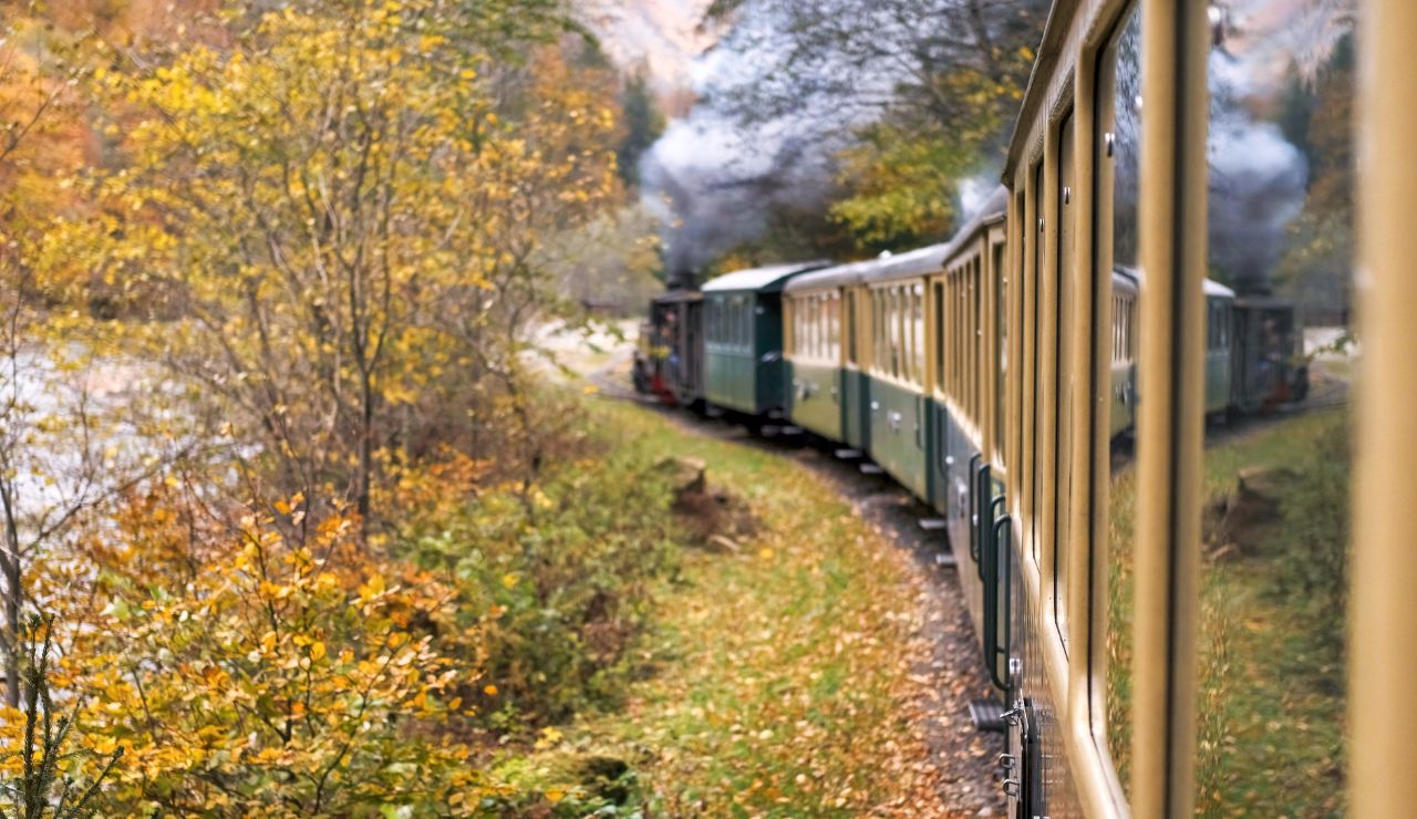 Glass-domed train car with breathtaking snowy Rockies visible, showcasing luxury and nature together.