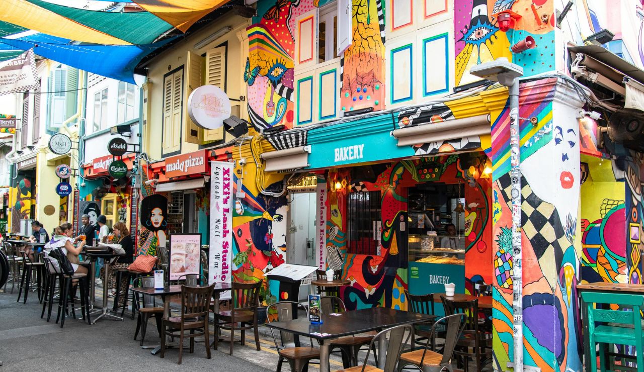 peopl exploring street art murals and food stalls in George Town.