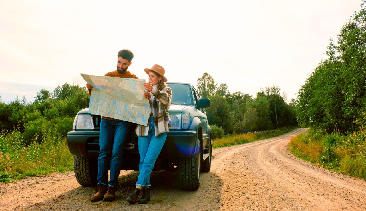 Couple sitting with a road map and planning their RV trip